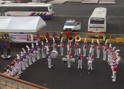bands entertaining ship passengers before departure as part of the luxury travel for world peace