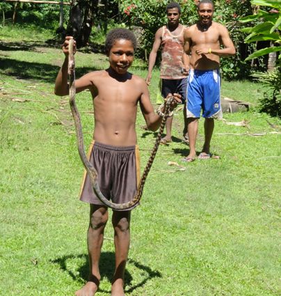 boy with snake madang in Papua New Guinea, found at one of our exotic luxury travel adventures